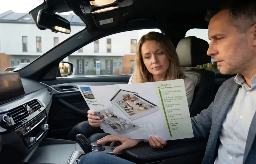 developer’s clients viewing an apartment card in a car